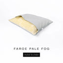 A Charley Chau Snuggle Bed, a cave bed or sleeping bag style dog bed made with a pale grey woven upholstery-quality fabric with cream, plush, faux-fur lining on a white backdrop.