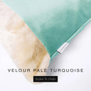 Close up of the corner of a luxury Dog Snuggle Bed, a cave bed style dog bed or sleeping bag style dog bed, with a pale turquoise blue upholstery-quality velour / velvet outer cover and plush cream faux-fur lining, showing a Charley Chau designer brand label on the dog bed, on a white background.