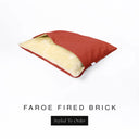 A Charley Chau Snuggle Bed, a cave bed or sleeping bag style dog bed made with a red woven upholstery-quality fabric with cream, plush, faux-fur lining on a white backdrop.
