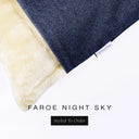 Corner detail of a luxury Dog Snuggle Bed, a sleeping bag style dog bed or cave bed style dog bed, with dark navy blue colored upholstery quality outer cover and plush cream faux-fur lining with Charley Chau's designer brand label.