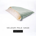 A luxury Dog Snuggle Bed, a cave bed style dog bed or sleeping bag dog bed, in upholstery-quality pale sage green Velour with a cream plush lining on a white backdrop.