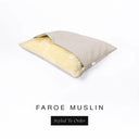 A Charley Chau Snuggle Bed, a cave bed or sleeping bag style dog bed made with a beige woven upholstery-quality fabric with cream, plush, faux-fur lining on a white backdrop.