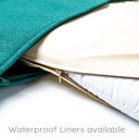 A close up shot of a jade colour dog  travel pad with the outer cover zip unzipped to reveal a cream waterproof bed liner and white internal mattress pad.