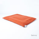 Luxury dog travel pad mattress in orange on a white backdrop. 