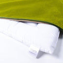 Detail close up shot of a luxury velvet dog travel pad in green velour with the zip unzipped to reveal the internal luxury mattress pad.