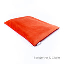 Luxury dog travel pad in velvet - by designers Charley Chau - in a bright orange velour with a contrast red piped edge on a white backdrop.
