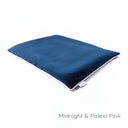 Slimline dog travel pad in a dark blue velour with a contrast pale pink piped edge on a white backdrop.