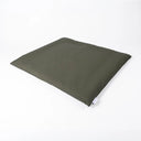 A tough, water-resistant travel dog bed and dog crate mattress in olive green Dry Wax Cotton Canvas, shown at an angle on a white studio background.