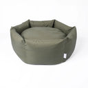 An olive green, luxury donut style dog bed that is water-resistant, with a deep-filled mattress and high, cosy sides, on a white background.
