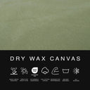 A close-up of the water-resistant dog bed fabric - an olive green Dry Wax Cotton Canvas with a black informational band below. The top portion shows the fabric texture, and the bottom band contains the text 'DRY WAX CANVAS' plus white performance icons and small feature labels.