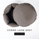 A luxury donut dog bed in warm taupe grey Cosmo fabric seen from above with the round mattress lifted out of the high-wall donut bed sides, on a white background with the text 'COSMO LOAM GREY' and a black 'Styled To Order' label.