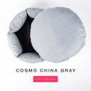 A light blue-gray premium donut style dog bed seen from above with the round mattress lifested out of the round high-wall donut bed sides, on a white background with the text 'COSMO CHINA GRAY' and a pink 'Core Collection' label.