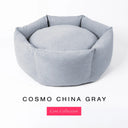 A pale blue luxury round donut dog bed, suitable for all breeds of dogs, with cosy high-wall dog bed sides and a deepfilled luxury mattress inside, on a white background with the text 'COSMO CHINA GRAY' and 'Core Collection' below.