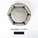 A top-down view of a pale flint grey-green luxury donut dog bed with high-wall padded sides and a round mattress inside, on a white background with the text 'COSMO FLINT' and a black 'Styled To Order' label below.