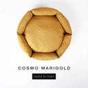 A top-down view of a warm golden marigold luxury donut dog bed with high-wall padded sides and a round mattress inside, on a white background with the text 'COSMO MARIGOLD' and a black 'Styled To Order' label below.