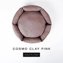 A top-down view of a dusty clay pink luxury donut dog bed with high-wall padded sides and a round mattress inside, on a white background with the text 'COSMO CLAY PINK' and a black 'Styled To Order' label below.