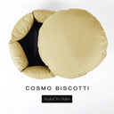 A luxury donut dog bed in pale golden beige Cosmo fabric seen from above with the round mattress lifted out of the high-wall donut bed sides, on a white background with the text 'COSMO BISCOTTI' and a black 'Styled To Order' label.