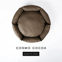 A top-down view of a warm cocoa brown luxury donut dog bed with high-wall padded sides and a round mattress inside, on a white background with the text 'COSMO COCOA' and a black 'Styled To Order' label below.