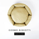 A top-down view of a pale golden beige luxury donut dog bed with high-wall padded sides and a round mattress inside, on a white background with the text 'COSMO BISCOTTI' and a black 'Styled To Order' label below.