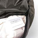 Close up shot of Charley Chau luxury donut dog bed with the zip cover unzipped revealing the ethically sourced feather pad insert and Charley Chau label.