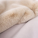 Close up detail of a luxury faux-fur dog blanket in golden fawn showing the plush faux-fur and soft fleece backing.