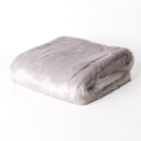 Picture of a folded pale purple Lilac Rabbit Faux Fur Dog blanket taken on a white backdrop.