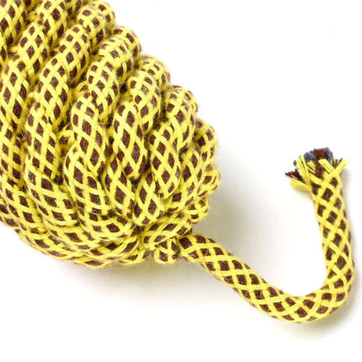 Close up of a dog toy made from yellow jute rope on a white background.