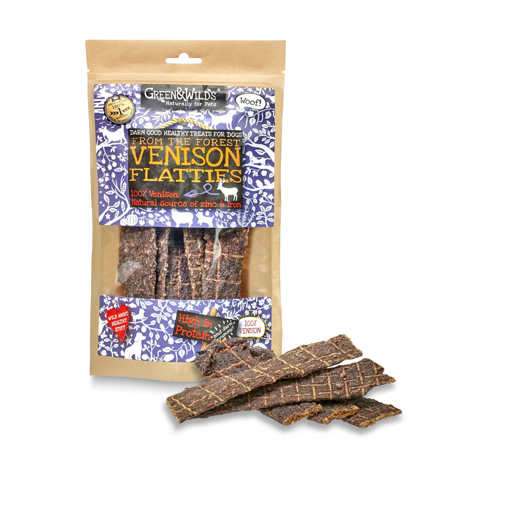 Package of Green & Wild's Venison Flatties dog treats on a white background with some Venison Flattie Dog Chews next to the package.