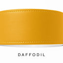 A close-up of a bespoke YELLOW leather dog collar with visible stitching, made with fine Italian Calf leather, labelled 'DAFFODIL' below on a white background.
