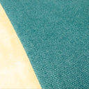 Close up detail of a jade green luxury dog snuggle bed with a cream faux-fur lining.