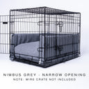 Black wire dog dog crate with a luxury dog crate mattress and crate bed bumper set in dark grey on a white backdrop.