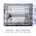 Black wire dog dog crate with a luxury dog crate mattress and crate bed bumper set in pale beige/grey on a white backdrop.
