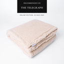 Folded beige luxury Sherpa Fleece Dog Blanket showing a designer label for Charley Chau on a white backdrop with "As recommended by The Telegraph" press feature badge above.