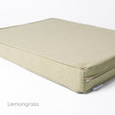 Close up shot of a luxury orthopaedic memory foam dog bed mattress with a durable pale green cover and a designer label for Charley Chau showing on a white backdrop. 