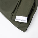 Close-up of the olive green Dry Wax Cotton Canvas fabric on a spare dog bed cover, showing the tough, water-resistant weave and the Charley Chau label.
