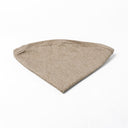 Folded Spare Dog Bed Cover for the round dog bed mattress inside the Charley Chau donut dog bed in beige on a white backdrop.