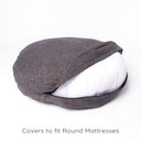 A deep-filled round dog bed mattress in a woven upholstery fabric in dark brown / black with the bed cover zip unzipped to show a white deep-filled mattress on a white backdrop.