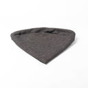 Folded Spare Dog Bed Cover for the round dog bed mattress inside the Charley Chau donut dog bed in dark brown / black on a white backdrop.