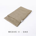 Folded Spare Bed Cover for a Charley Chau luxury dog snuggle Bed and dog burrow bag in a beige, textured upholstery fabric that is scrabble resistant and scratch resistant, with text "Weave II - Oak".