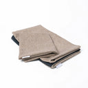 Folded Spare Cover for Charley Chau's Luxury Bliss Bolster Dog Bed in a beige woven upholstery fabric.