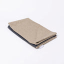 Folded Spare Cover for Charley Chau's Luxury Bliss Bolster Dog Bed in a beige woven upholstery fabric.