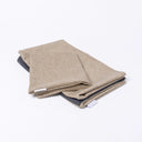 Folded Spare Covers for Charley Chau's Luxury Bliss Bolster Dog Bed in a beige woven upholstery fabric