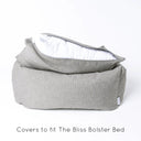 Luxury box-style dog bed, Charley Chau's luxury Bliss Bolster dog Bed in a grey colour with the mattress lifted up slightly and the mattress cover unzipped to show the internal mattress insert on a white backdrop.