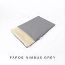 A folded spare dog bed cover to fit Charley Chau Snuggle Dog Beds and Burrow Bags with mid grey outer cover in woven wool texture upholstery-quality Faroe and plush cream faux-fur lining on a white backdrop.