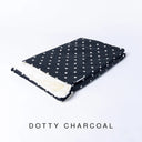 A folded spare dog bed cover to fit Charley Chau Snuggle Dog Beds and Burrow Bags with charcoal polka dot outer cover in Dotty Cotton and plush cream faux-fur lining on a white backdrop.