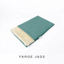 A folded spare dog bed cover to fit Charley Chau Snuggle Dog Beds and Burrow Bags with jade green outer cover in woven wool texture upholstery-quality Faroe and plush cream faux-fur lining on a white backdrop.