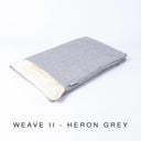 A folded spare dog bed cover to fit Charley Chau Snuggle Dog Beds and Burrow Bags with light blue-grey outer cover in upholstery-quality Weave II and plush cream faux-fur lining on a white backdrop.