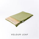 A folded spare dog bed cover to fit Charley Chau Snuggle Dog Beds and Burrow Bags with moss green outer cover in upholstery-quality Velour and plush cream faux-fur lining on a white backdrop.