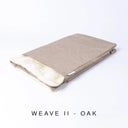 A folded spare dog bed cover to fit Charley Chau Snuggle Dog Beds and Burrow Bags with pale rosy beige outer cover in upholstery-quality Weave II and plush cream faux-fur lining on a white backdrop.