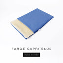 A folded spare dog bed cover to fit Charley Chau Snuggle Dog Beds and Dog Burrow Bags with bright blue outer cover in woven wool texture upholstery-quality Faroe and plush cream faux-fur lining on a white backdrop.